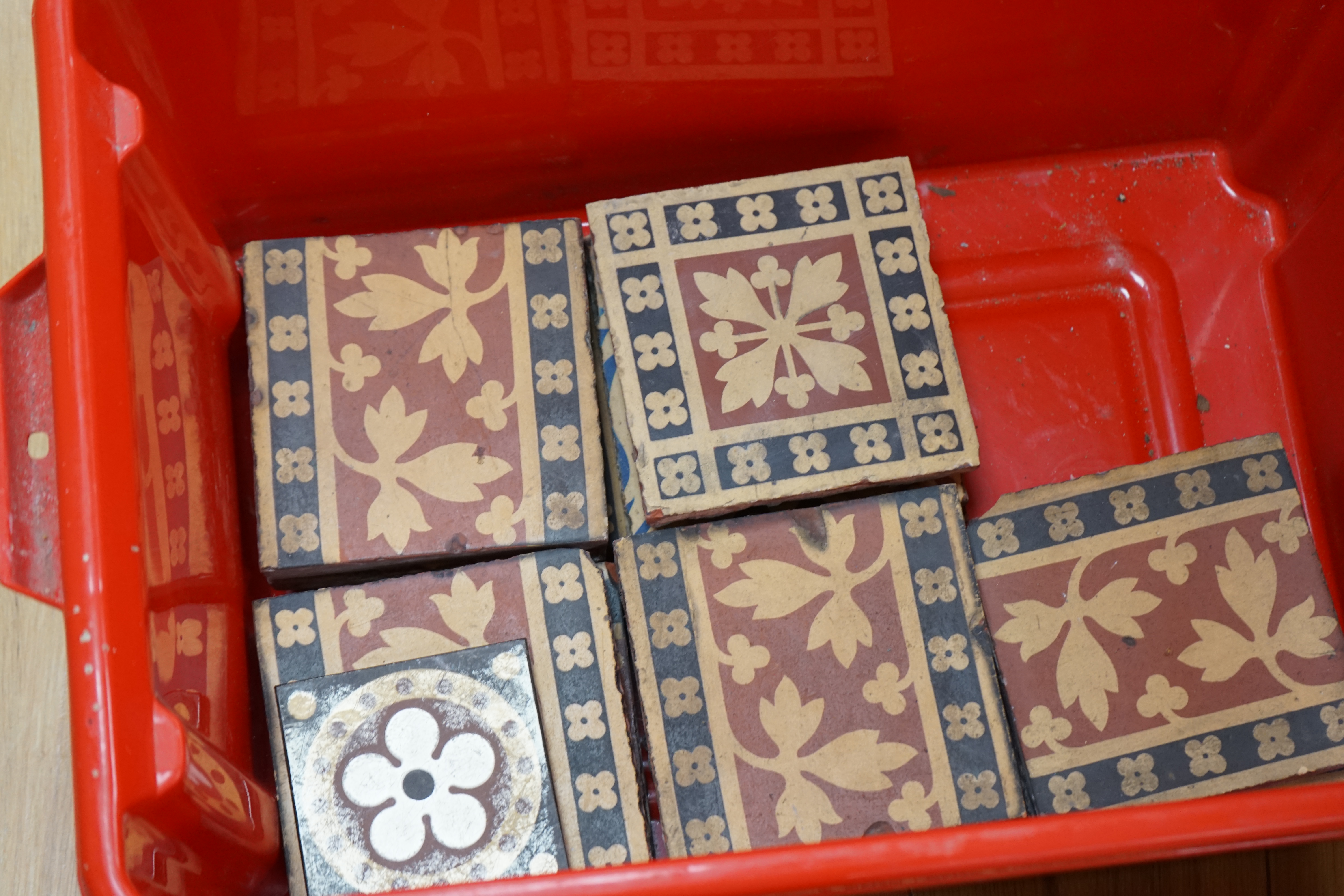 A W N Pugin encaustic tiles by Minton and Co, twenty six and one smaller, together with a group of four similar framed 19th century tiles. Condition - good